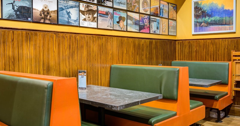 Dining booths by the walls decorated with retro images