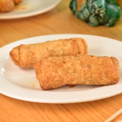 Egg rolls on a white plate.