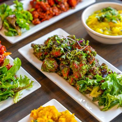 Green chili fried chicken accompanied with other dishes.