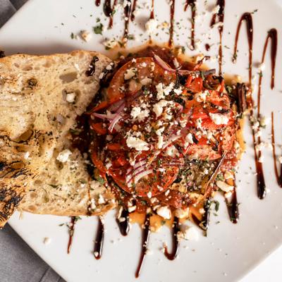 Grilled Eggplant drizeled with balsamic glaze with toeast on the side.