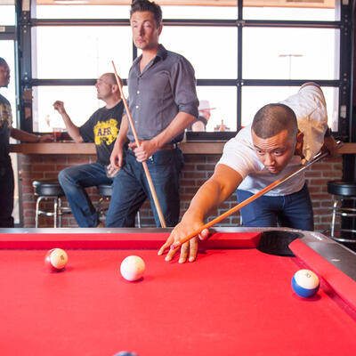 Two guests playing pool