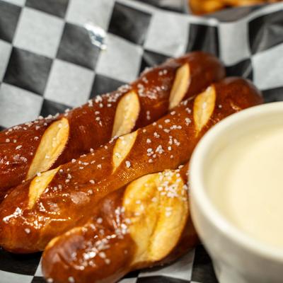 Pretzel sticks served with a warm cheese dip.