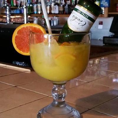 Mimosa with an upside down bottle inside a glass.