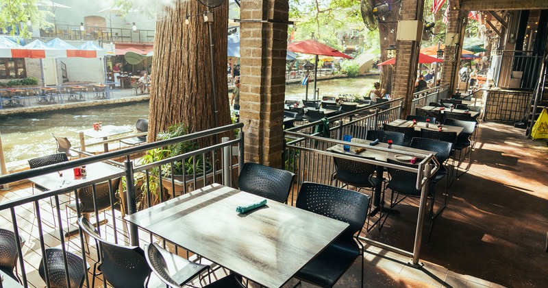 Spacious and cozy patio dining area with dining tables set for guests