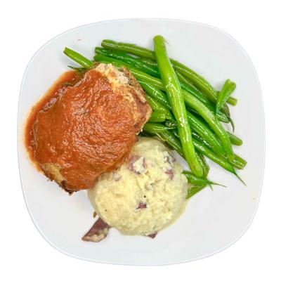 Meatloaf with red sauce, green beans, and mashed potatoes.