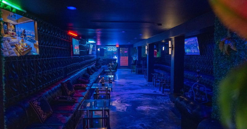 Interior, tables, chairs and long, high back wall benches