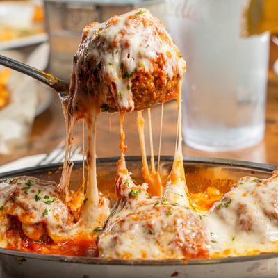 Meatballs, in meat sauce and melted cheese.
