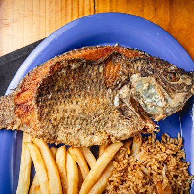 Fried Whole Tilapia with fries and rice.