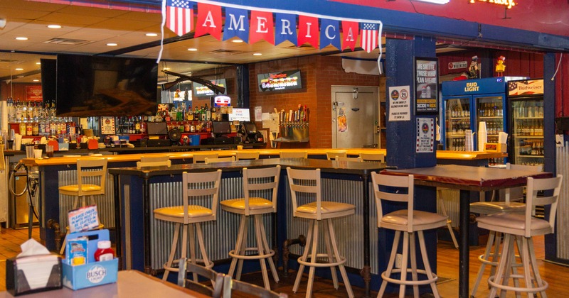Interior, bar and seating area with an America banner hanging