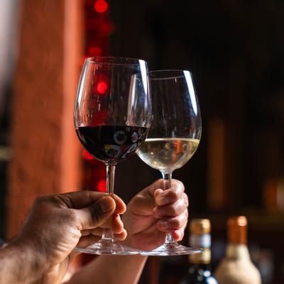 Hands holding glasses of wine.