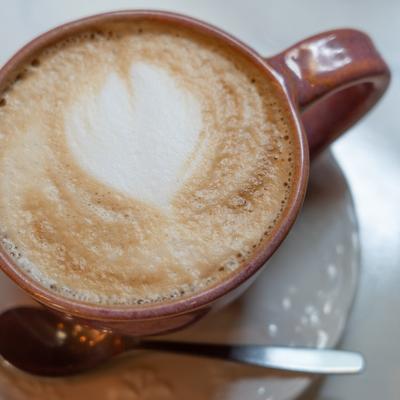 Frothy cappuccino with heart-shaped foam art.