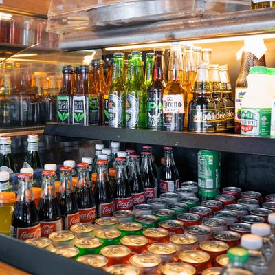 Numerous bottled and canned drinks.