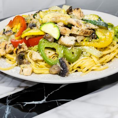 Grilled chicken with vegetables on pasta.