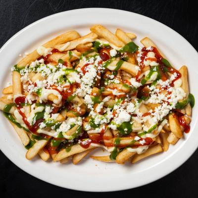 Loaded fries drizzled with sauces and topped with cheese.
