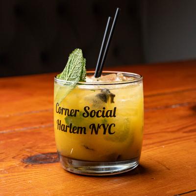 The Lion cocktail garnished with mint leafs.