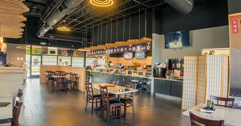 Spacious sushi restaurant interior space, dining area with sushi bar