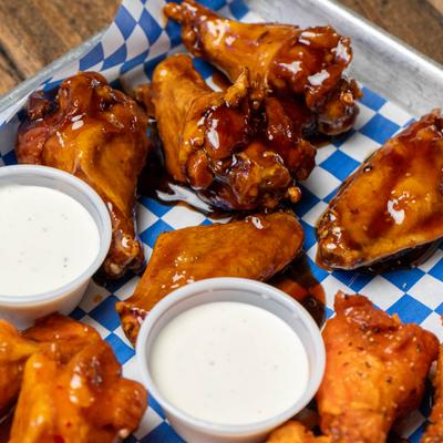 Buffalo and BBQ chicken wings, with dipping sauces.