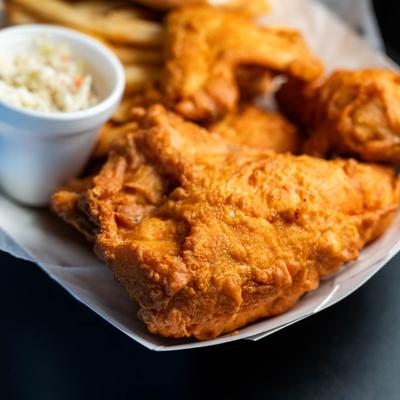 Fried chicken served with coleslaw.