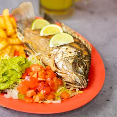 Whole fish, fries, and guacamole.