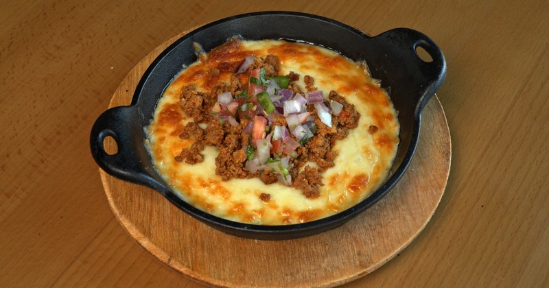 Melted cheese dip with chorizo
