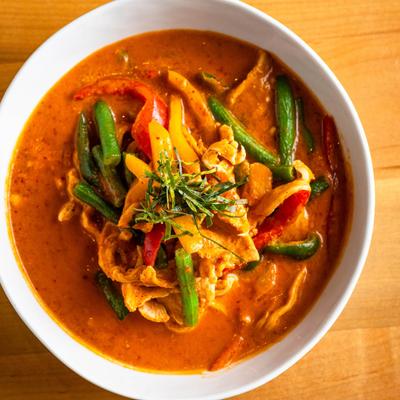A rich and creamy Thai red curry with shredded kaffir lime leaves.