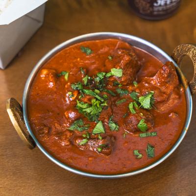 Indian lamb curry topped with fresh herbs.
