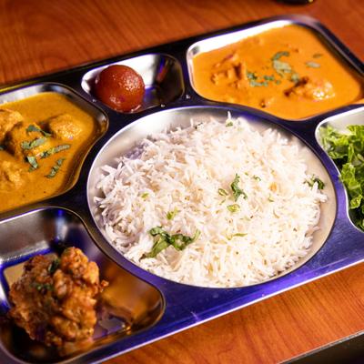 Lunch thali with curries, rice, and salad.