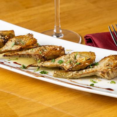 Grilled artichoke hearts with fresh herbs and balsamic drizzle.