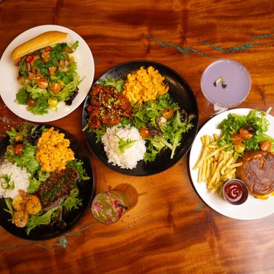Variety of dishes served ob the table with cocktails, top view.