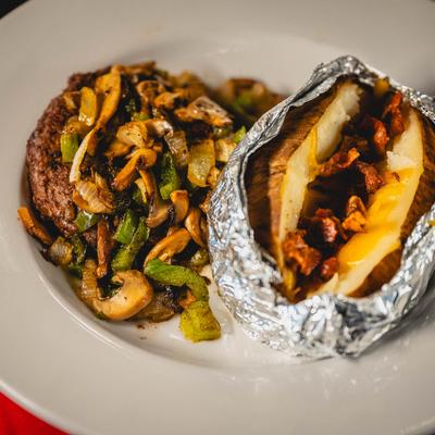 Grilled steak, with sauteed veggies, and loaded baked potato.