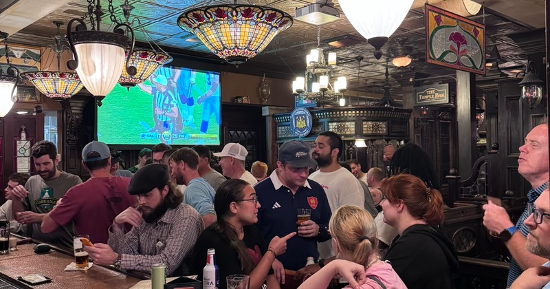 Bustling pub scene with diverse patrons chatting and enjoying drinks