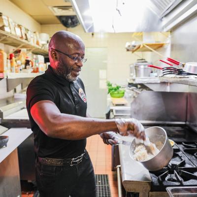 Cheff preparing food in a professional kitchen.