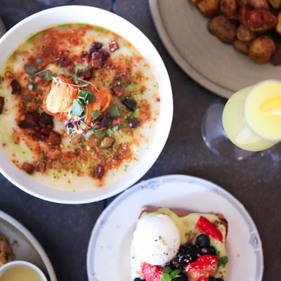 Rice porridge with pork served with a drink and a French toast.