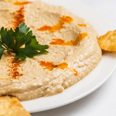 Hummus topped with paprika, oil, and parsley.