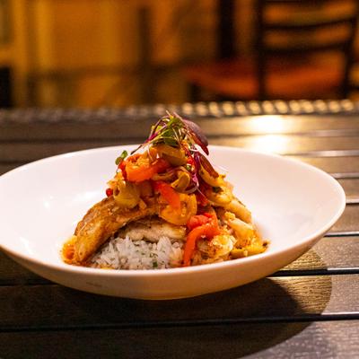 Seared Rockfish, with jasmine rice, olives, garlic, shallots, tomatoes, red peppers, and capers.