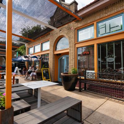 Outdoor restaurant patio with tables and umbrellas.