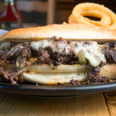Cheesesteak sandwich and onion rings.