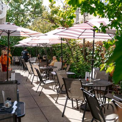 Restaurant's patio with tables, chairs and umbrellas.