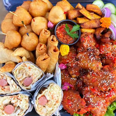 Assorted appetizers, wraps, and chicken.