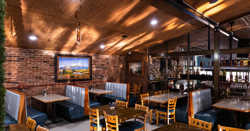 Cozy restaurant interior with exposed brick walls and wooden ceiling