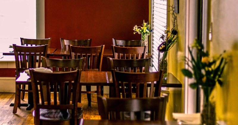 Interior, lined up tables and chairs, closeup