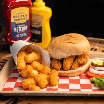 Chicken tender sandwich with tater tots.