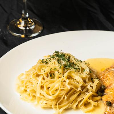 Chicken Piccata, plated and served on the table.