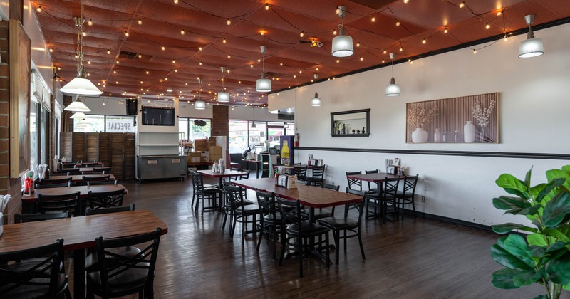 Interior, wide view, tables and chairs ready for guests
