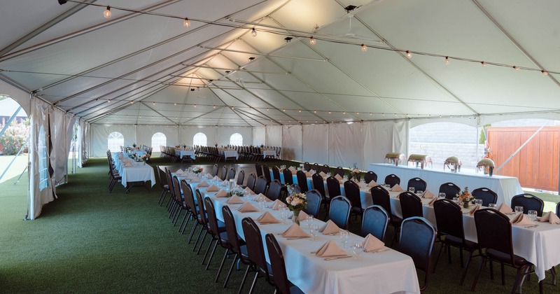 Interior, wedding tent, long dining tables, tableware