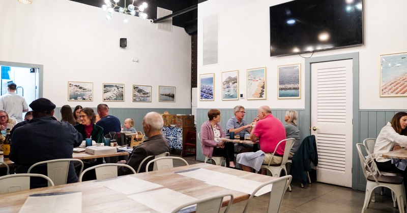 Interior space, dining area with guests chatting and enjoying their food