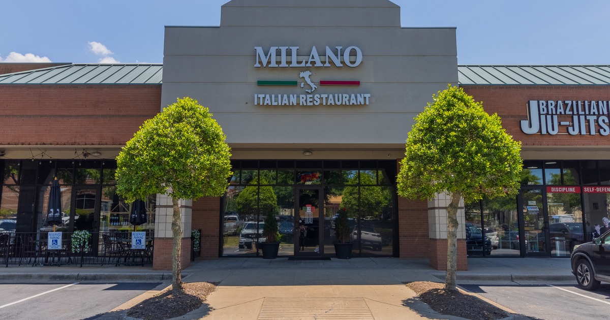 Restaurant front entrance with two trees planted on the sidewalk