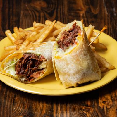 BLT Wrap sliced in half and served with fries.