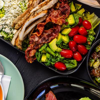Cobb salad, with grilled chicken, bacon, avocado, eggs, blue cheese, tomato, and lettuce.