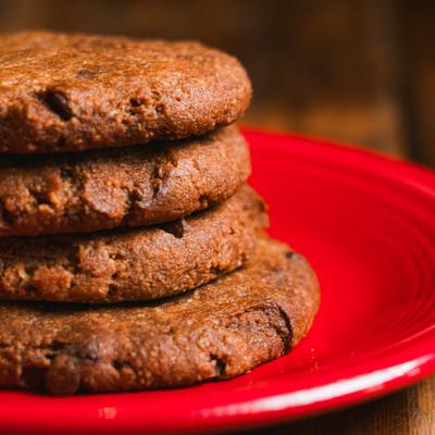 Stack of cookies served on a red plate.